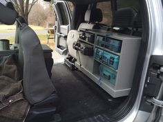 the back end of a van with an entertainment system in it's cargo area