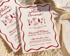 two red and white wedding cards with wine related items on them, sitting next to each other