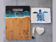 a cutting board, spoon and towel with a sea turtle on it