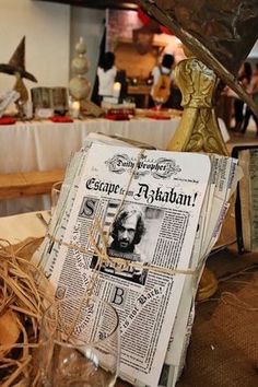 a table topped with lots of newspapers and glasses