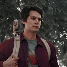 the young man is holding two large objects in his hands