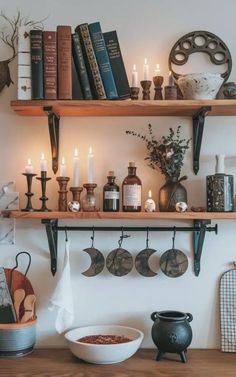 the shelves are filled with books, candles and other things to decorate in this room