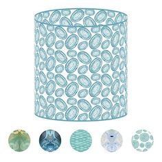 a blue lamp shade with four different designs on the bottom and one light in the middle