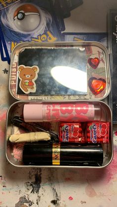 an open tin with various items in it