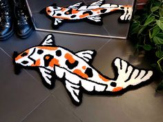 two fish rugs on the floor in front of a mirror