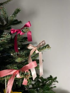 a christmas tree with ribbons hanging from it