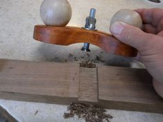 a person working with woodworking tools on a piece of wood and screwdriver