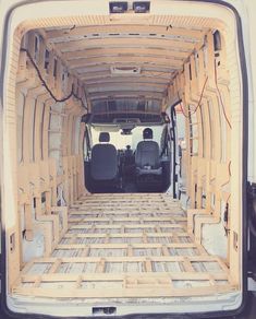 the back end of an empty van with its doors open