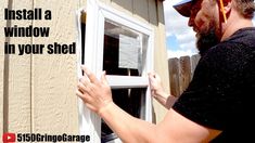 a man is installing a window in his shed