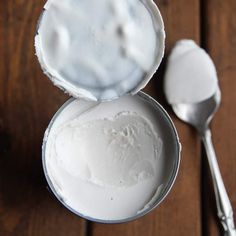 a spoon and some white cream in a tin