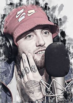 a man with headphones and tattoos on his face next to a microphone