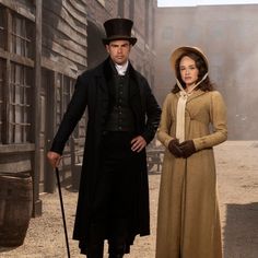 the man and woman are dressed in period clothing