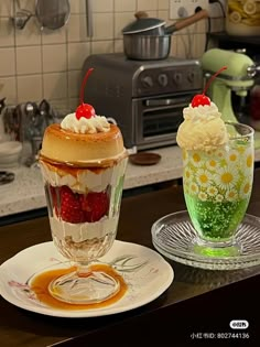 two desserts sitting on top of plates in a kitchen