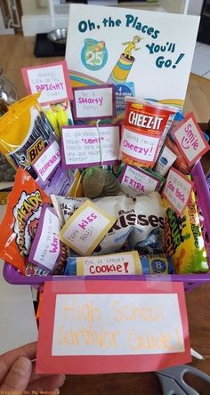 a basket filled with lots of different types of snacks and candy bars on top of a table