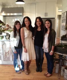 three women standing in a kitchen next to each other smiling for the camera and posing for a photo