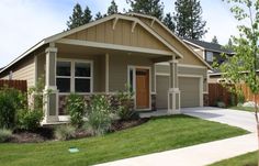 a house with two garages in the front yard