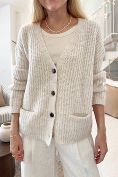 The Isabella Knit Cardigan is a beautiful oatmeal color, that will mix and match beautifully with all of your fall wardrobe! It has the sweetest wooden buttons that truly add a special touch to the piece! Featuring a button down front, v neckline, knit fabric, oatmeal color, and a true to size fit. Style the piece with linen pants and a tank top while out running errands! Details & Sizing V neckline Knit fabric Oatmeal color True to size fit Gabriella is wearing a size S/M Fabric 73% Acrylic 14% Beige Knit V-neck Cardigan, Everyday Beige V-neck Outerwear, Cozy Everyday Cardigan With Buttons, Everyday Cozy Cardigan With Buttons, Cozy Everyday Cardigan With Button Closure, Cream Knit Button-up Cardigan, Beige V-neck Cardigan With Button Closure, Beige Cardigan With Buttons For Layering, Beige Buttoned Cardigan For Layering