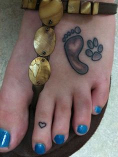 a woman's foot with two different designs on it and a dog paw tattoo