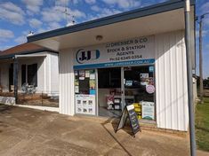 the front entrance of a building with signs and signage on it's side,