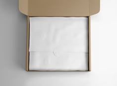 an open box with two white sheets in it