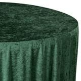 a round table covered in green velvet