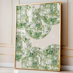 an abstract painting with green and white tiles on the wall next to a gold frame