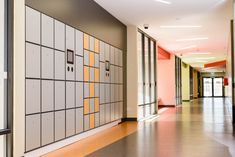 an empty hallway with several lockers on the wall