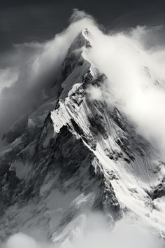 the top of a mountain covered in clouds