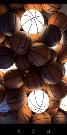 a bunch of basketballs that are stacked together