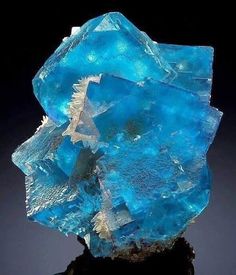 a piece of blue glass sitting on top of a table