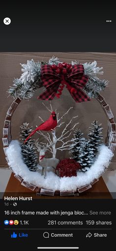 a glass bowl with a cardinal and pine trees in it