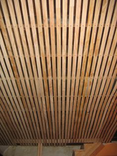 the ceiling is made out of wood and has vertical slats on it's sides