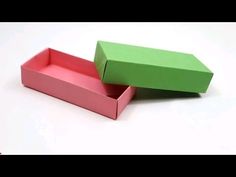 two green and pink boxes sitting on top of each other