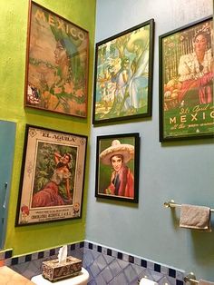 a bathroom with pictures on the wall and toilet