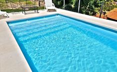 an empty swimming pool with blue water