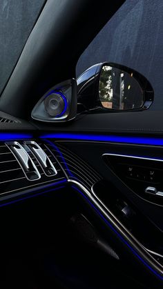 the interior of a car is shown with blue lights and black dash strips on it