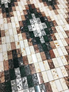 a tiled floor with different colored tiles on it