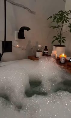 a bathtub filled with bubbles and candles