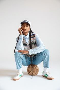 a woman sitting on top of a ball while holding a cell phone to her ear