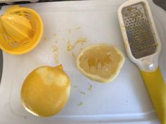 a lemon and grater sitting on top of a cutting board