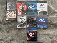 several different video games on display in front of a granite wall with the title gt2