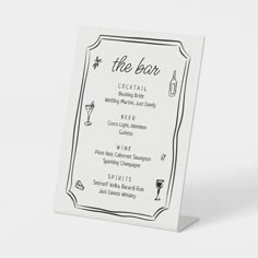 a white and black menu card with the word, the bar on it's front