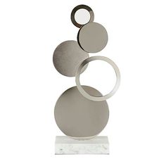 a metal sculpture with three circles on it's top and one circle in the middle