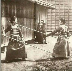 an old black and white photo of two women shaking hands