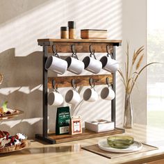 a shelf with coffee mugs and other items on it next to a wall mounted pot rack