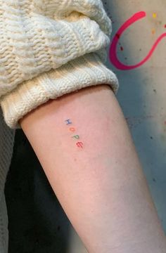 a person with a small tattoo on their arm