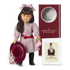 an american girl doll with hat and book