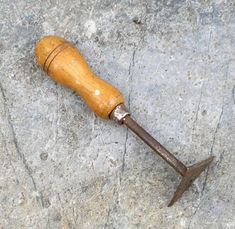 an old rusty hammer laying on the ground