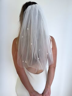 the back of a woman wearing a wedding veil