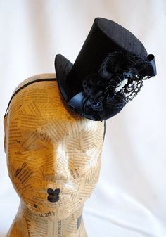 This victorian goth mini top hat is a simple yet elegant piece.It is covered with black silk shantung and adorned with black satin ribbon in a vertical half bow, vintage black cotton lace in a rosette, pleated satin ribbon, which forms an oval frame for a beautiful black and white victorian profile cameo. Choose between with or without black veil. Also available in a white and black combination: https://www.etsy.com/bizarrenoir/listing/166826619/gothic-mini-top-hat-in-purple-velvet?ref=shop_home Gothic Black Hats And Headpieces For Themed Events, Gothic Black Costume Hats And Headpieces For Themed Events, Black Top Hat For Costume, Black Fitted Top Hat For Costume, Fitted Black Top Hat For Costume, Gothic Black Top Hat For Costume Party, Black Gothic Top Hat For Costume Party, Black Gothic Mini Hat With Adjustable Fit, Black Gothic Mini Hat Adjustable